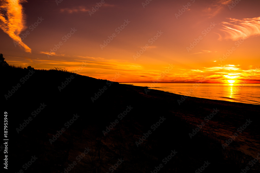 Silhouette of sunset beach, landscape with sun on the sky going to the sea, summer background