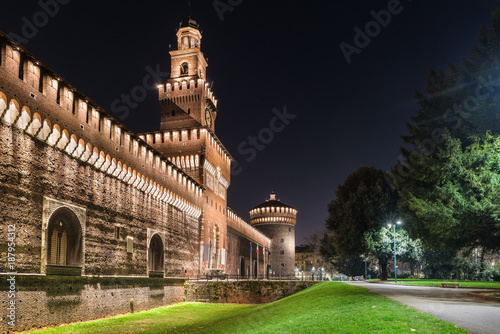 Milan, Italy. Public pedestrian path in front of the castello Sforzesco (Sforza Castle) main entrance  (14 - 15th century),  in the evening. The sforza castle is one of the monuments symbol of Milan photo