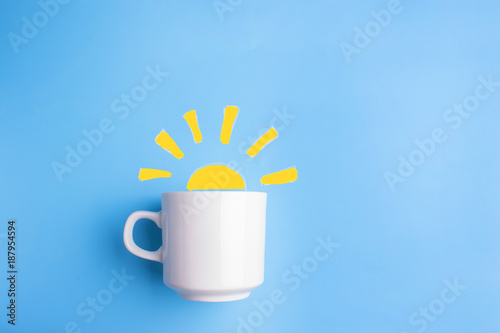 Obraz na plátně sun and white cup on blue background