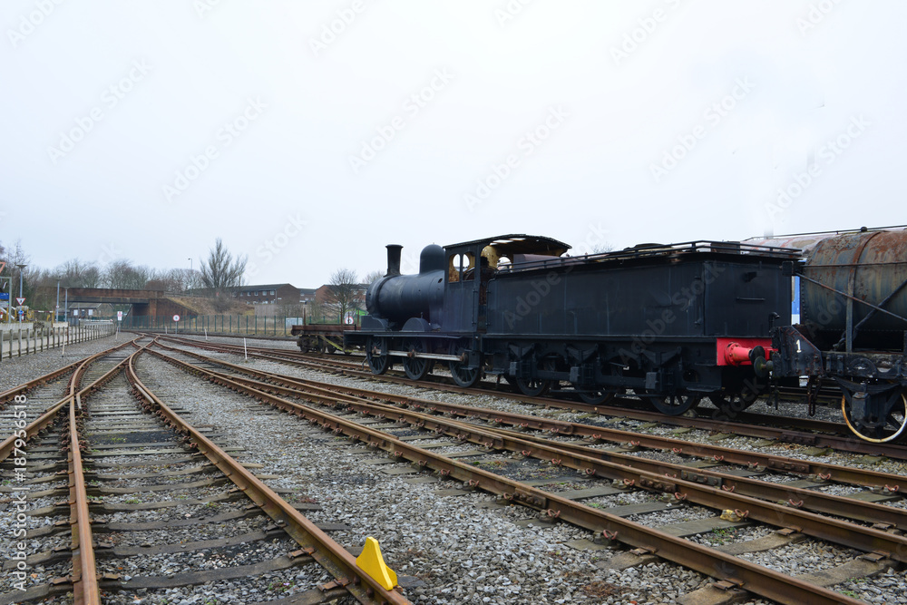 An old steam locomotive left in a railway siding in the UK. An old steam locomotive left in a railway siding in the UK.