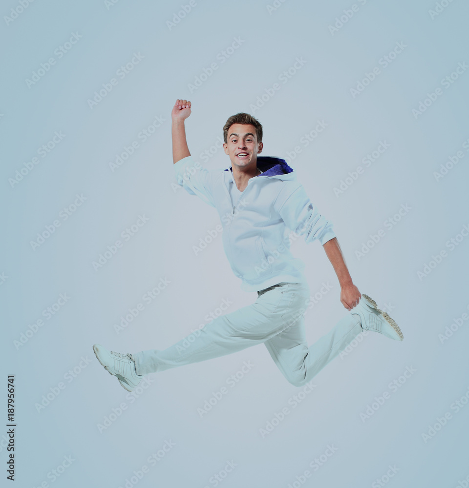 Jumping young man. Isolated over blue background. Jumping young man. Isolated over blue background.