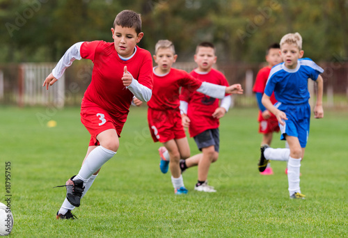 Young children players football match on soccer field