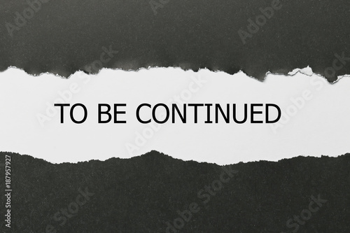 The text to be continued appearing behind torn paper