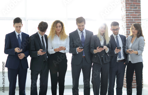 business team looking to smartphone in office