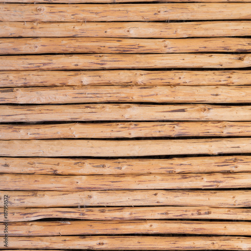 wooden wall from horizontally arranged logs, background texture