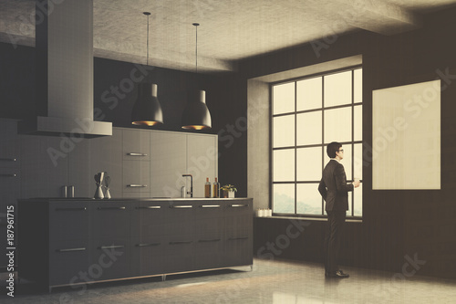 Gray kitchen corner, square window, man