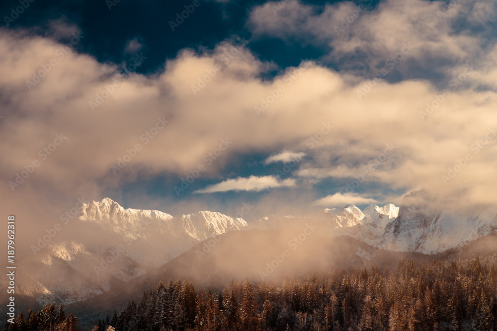 Fototapeta premium Mangart capped by the fog in a winter day