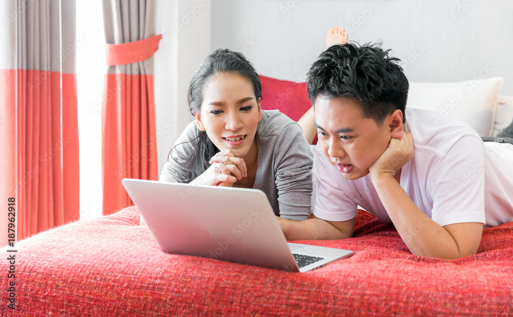 Couples using laptop bedroom Couples using laptop bedroom