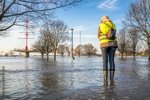 Lady standing in flooded street photo