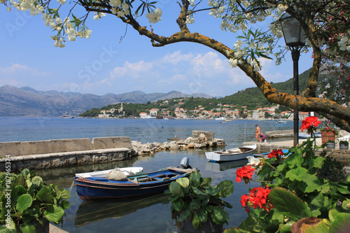 view of a blue fishing boat in the Gulf of Lopud Island, Croatia. in the background of the mountain