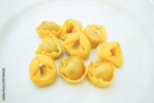 Italian traditional tortellini pasta over white plate. Healthy diet. Mediterranean cuisine. Toned photo. Vintage filter applied.