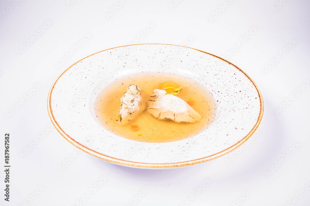 Dumplings in broth with an egg yolk on a white background Dumplings in broth with an egg yolk on a white background