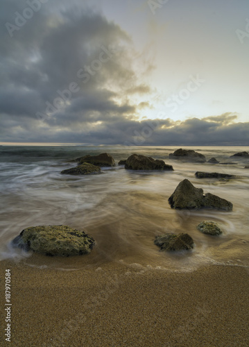 Fototapeta Naklejka Na Ścianę i Meble -  seascape of Silky sea with rocks against a colorful sky at sunrise .