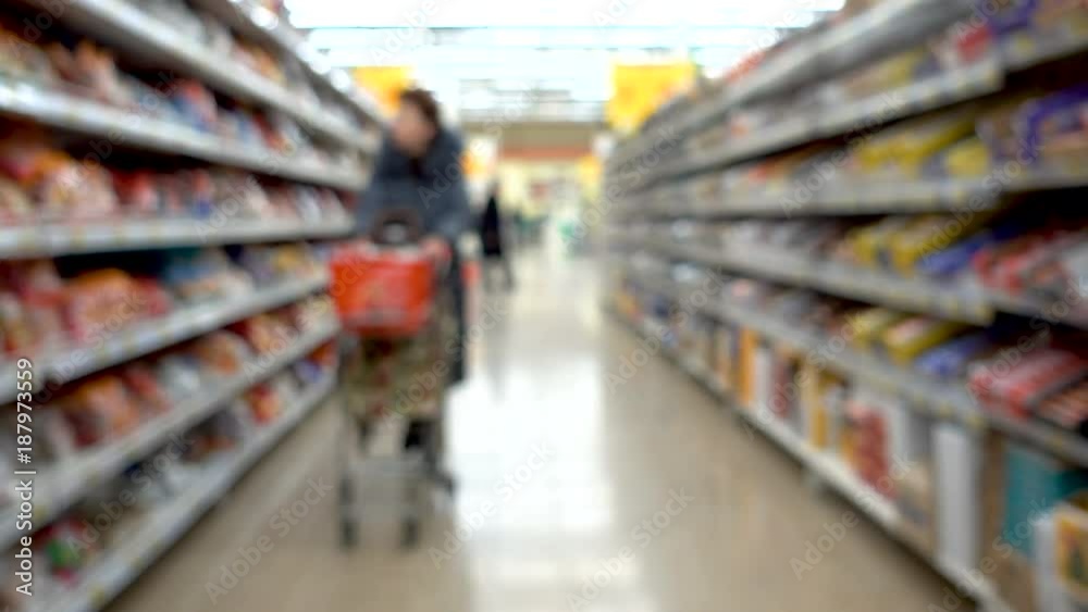 shop, blurred background, people with shopping carts. People are shopping in a supermarket, defocused blurred background shop, blurred background, people with shopping carts. People are shopping in a supermarket, defocused blurred background