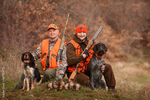 hunters with dogs hunting a bird woodcock