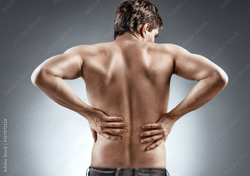 Fototapeta premium Kidneys pain or lower back pain. Man holding his back. Medical concept.