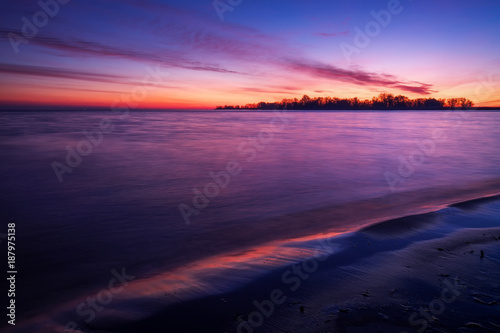Beach against red fiery sunset. Sunrise and sea © es0lex