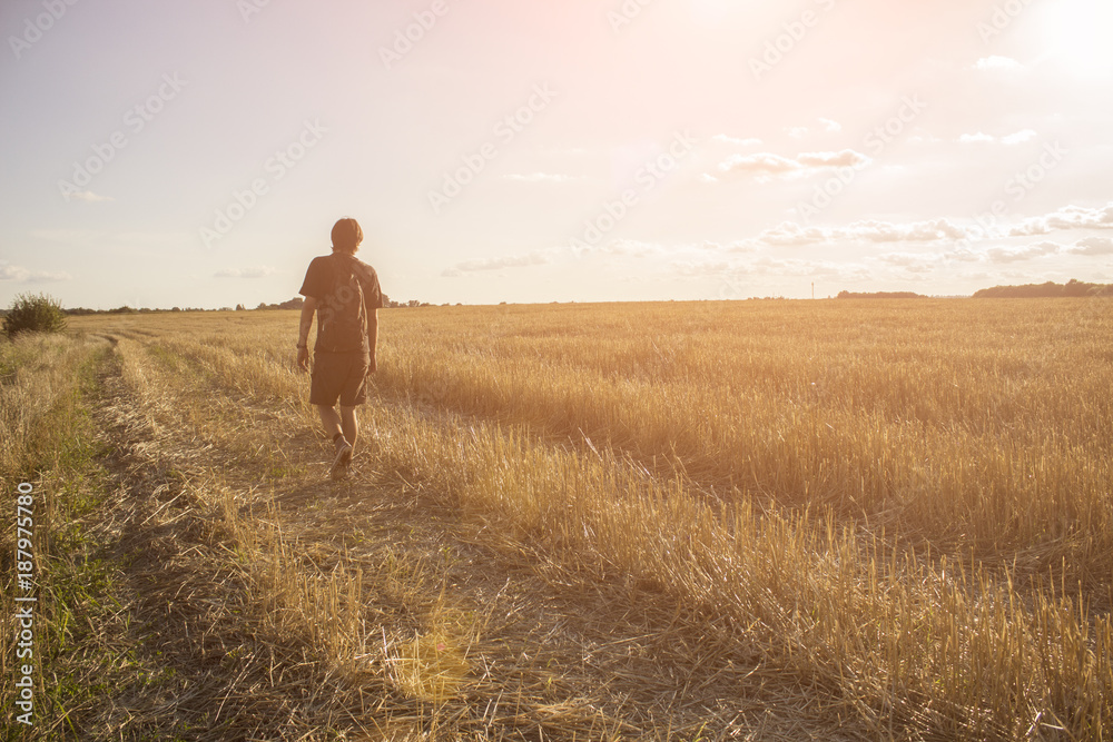 Fototapeta premium Guy is walking around the field