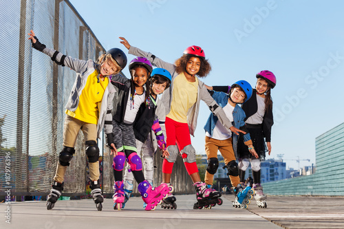 Happy sporty inline skaters having fun outdoors