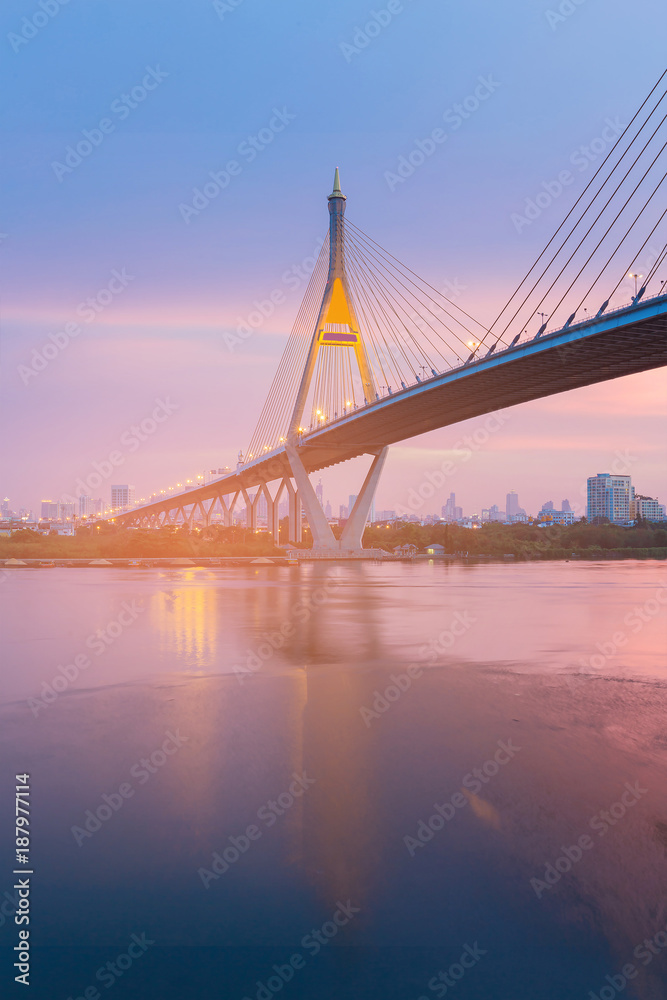 Naklejka premium Night suspension bridge with after sunset skyline