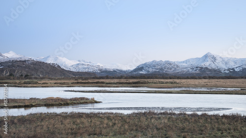 Beautiful Winter sunrise landscape image of Mount Snowdon and other peaks in Snowdonia National Park
