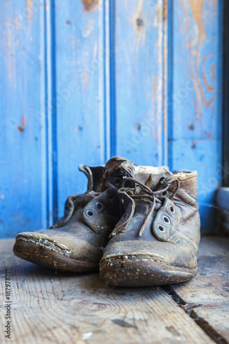 Old worn shoes on a wooden floor
