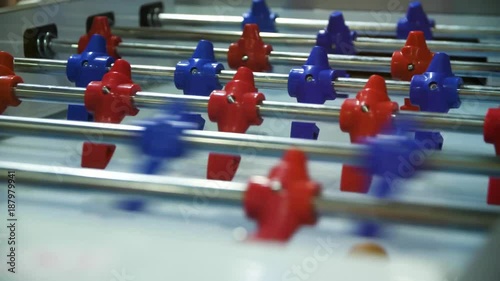 Two hands of two people playing Table Football in relax times for entertainment. Two friends play table football photo