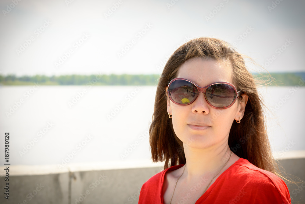 Portrait of beautiful girl with glasses on the promenade by the river Portrait of beautiful girl with glasses on the promenade by the river