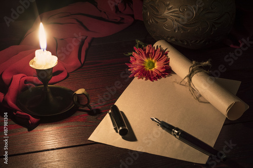 The candle illuminates the Desk where the letter