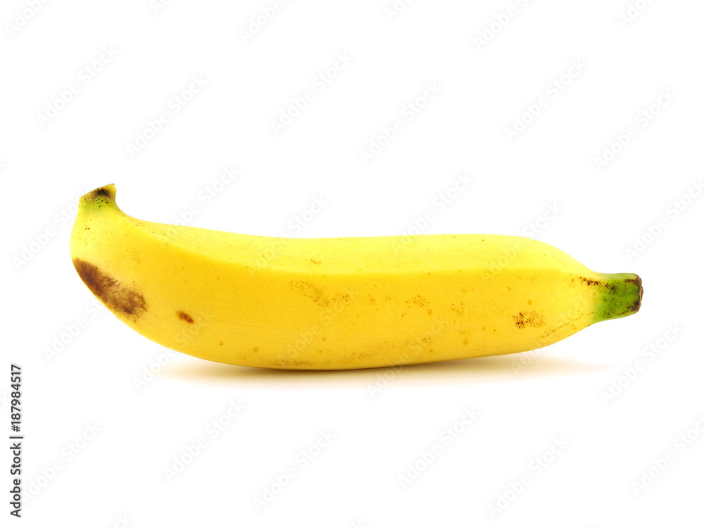 side of single yellow ripe banana with peel spotted isolated on white