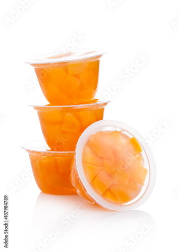 Single cups with peach in fruit jelly