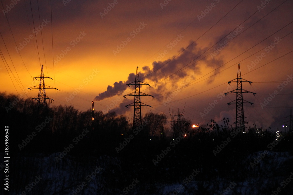 tower power plant in the background of a winter sunset and clouds