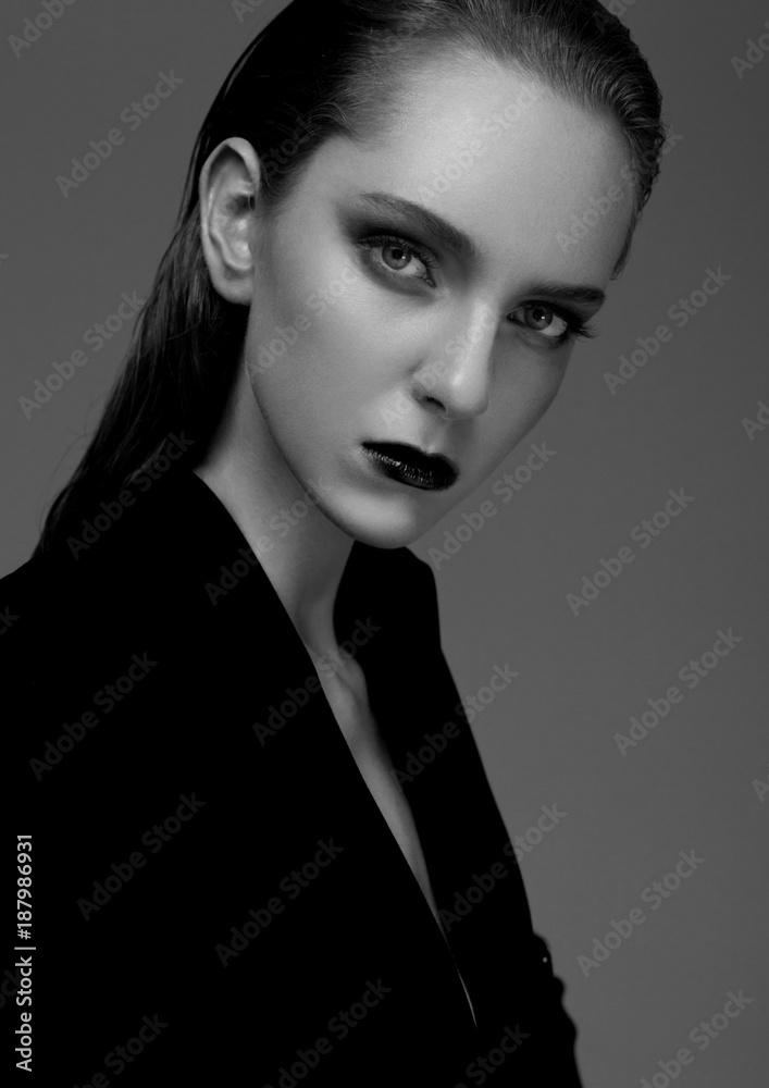 Fototapeta premium Fashion model with wet hair wearing black coat