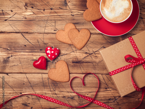 Valentines day background with coffee cup, heart shape cookies and gift box. Top view. Flat lay