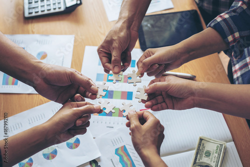 Canvas Print close up hand of group business partnership people puting together a jigsaw puzz