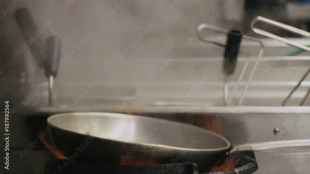 Chef is stirring vegetables in a pan Chef is stirring vegetables in a pan