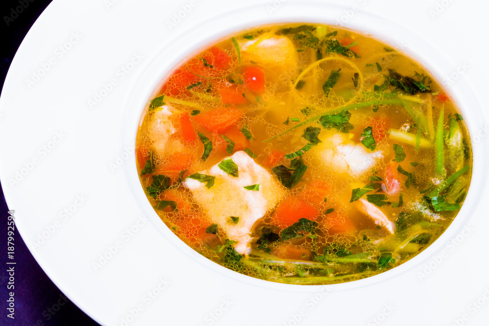 Fish soup with vegetables and herbs in white plate Fish soup with vegetables and herbs in white plate