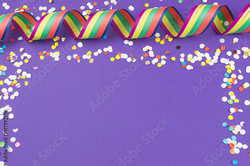 Party background in ultra violet color, with streamers and confetti, copy space