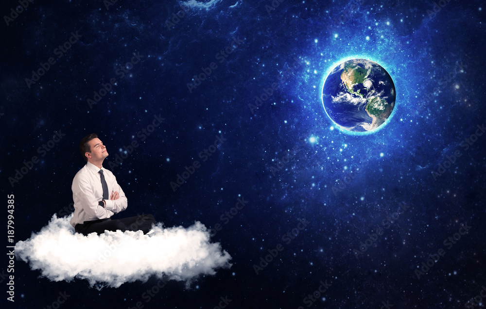 Man sitting on cloud looking at planet earth