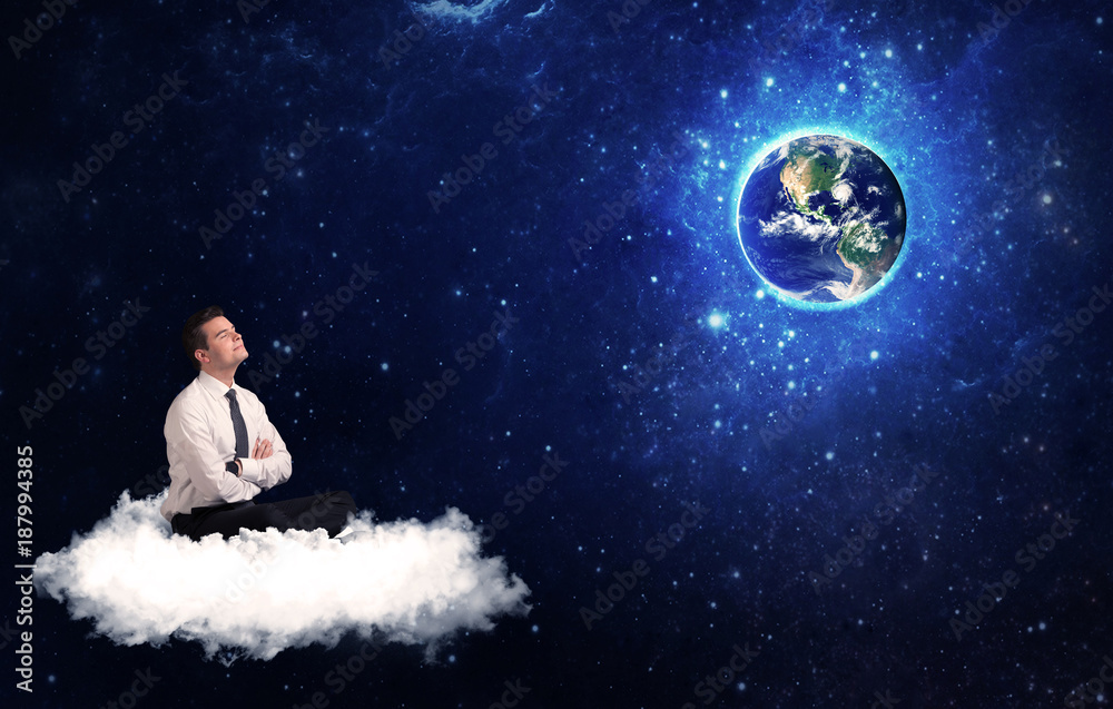 Man sitting on cloud looking at planet earth Man sitting on cloud looking at planet earth
