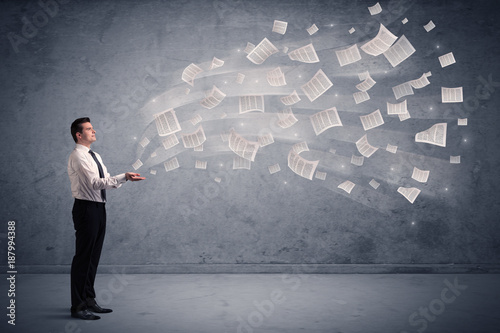 Caucasian businessman holding newspapers