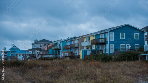 Beach houses and grass with storm clouds © David