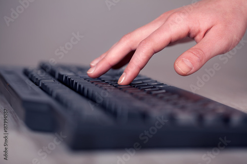 Close up of hand pressing keyboard buttons