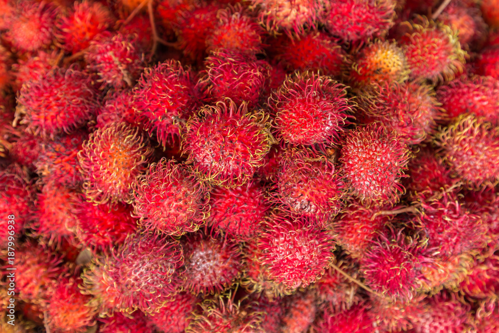 Close-up off Rambutan or red hairy lychee on the market on Java, Indonesia Close-up off Rambutan or red hairy lychee on the market on Java, Indonesia