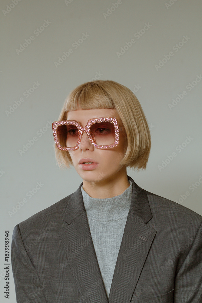 Blonde girl with short hair style in fashion glasses Blonde girl with short hair style in fashion glasses