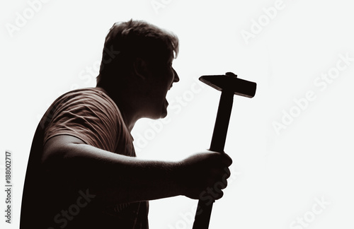 An aggressive man attacks with a hammer. Assault with a hammer. Hand with a hammer. Murder with a hammer.