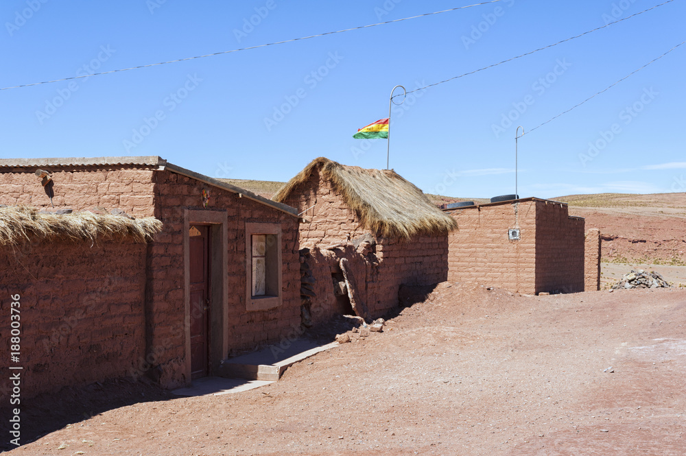 Adobe house in Cerrillos village on Bolivian Altiplano near Eduardo Avaroa Andean Fauna National Reserve with blue sky, Bolivia - South America