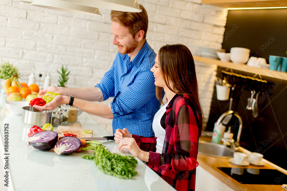 Young couple preparing healthy meal in the kitchen Young couple preparing healthy meal in the kitchen