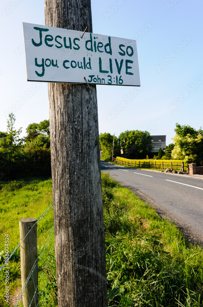 Sign on a lampost with hand-written message 