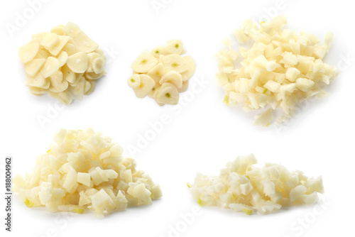 Set with raw fresh chopped garlic on white background